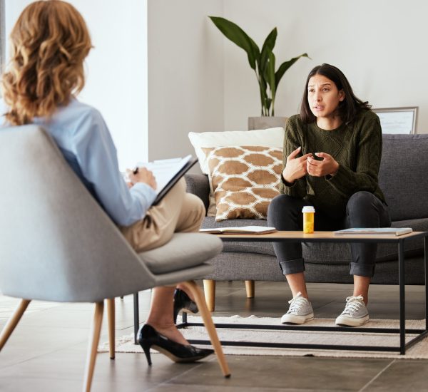 Shot of a young woman having a therapeutic session with a psychologist